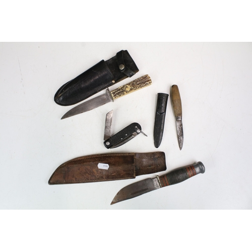 285 - A small group of knives to include two sheath knives and a military jack knife.