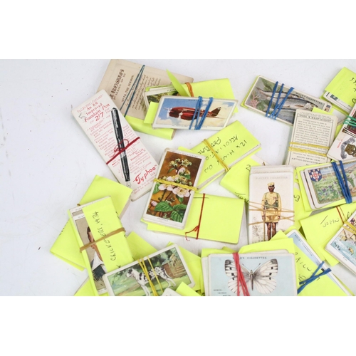 293 - A small collection of mixed cigarette cards together with a collection of football related enamel ba... 