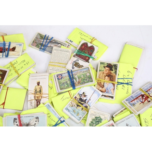 293 - A small collection of mixed cigarette cards together with a collection of football related enamel ba... 