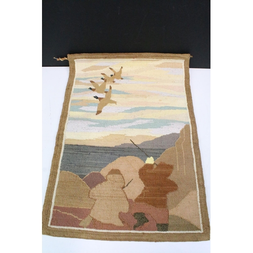 296 - A Canadian inuit tapestry together with an inuit leather dog whip with wooden handle.