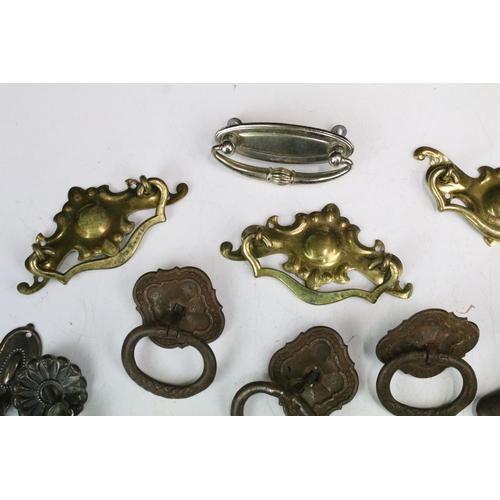 301 - Collection of furniture handles including set of four brass handles with shaped back plates, set of ... 