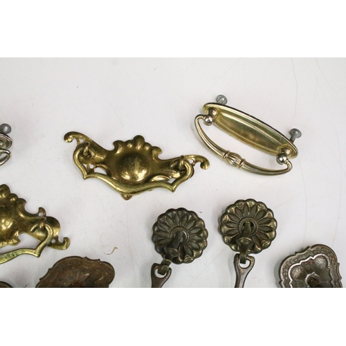 301 - Collection of furniture handles including set of four brass handles with shaped back plates, set of ... 