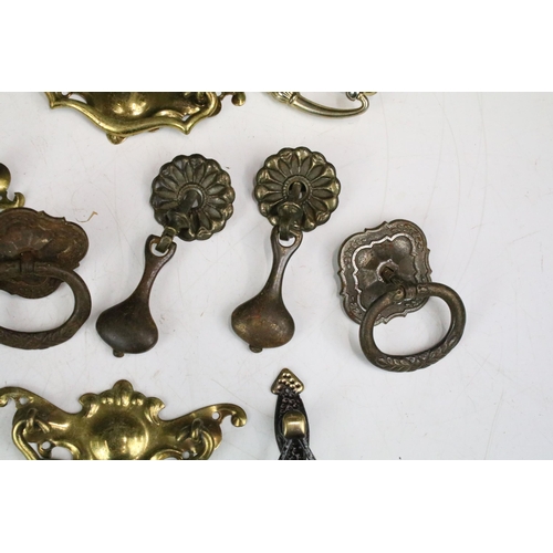 301 - Collection of furniture handles including set of four brass handles with shaped back plates, set of ... 