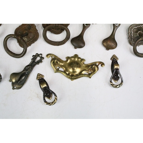 301 - Collection of furniture handles including set of four brass handles with shaped back plates, set of ... 