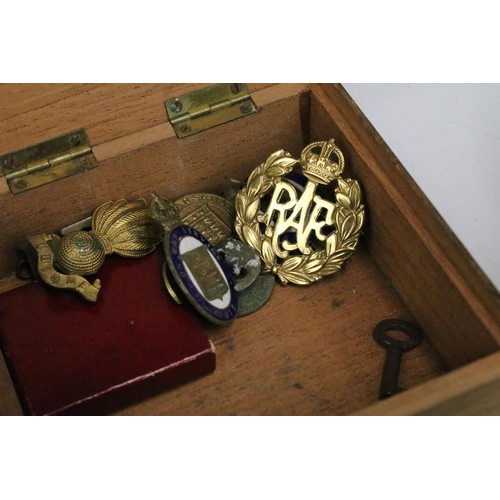 304 - A small group of mixed collectables to include military badges, keys and driving medal.