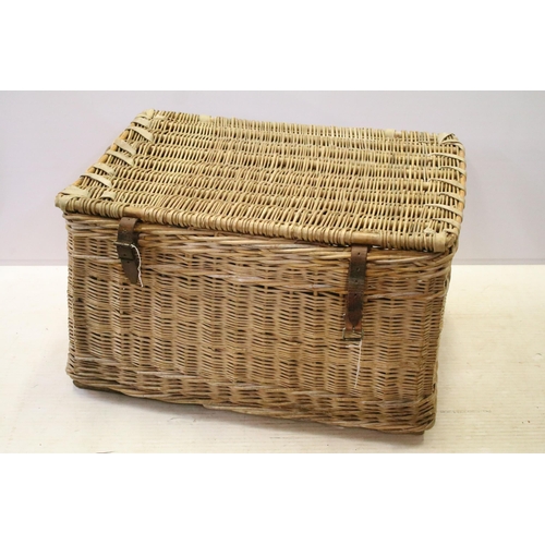 654 - Early 20th century wicker hamper with liftable lid and strap closure, H 48cm W 80cm