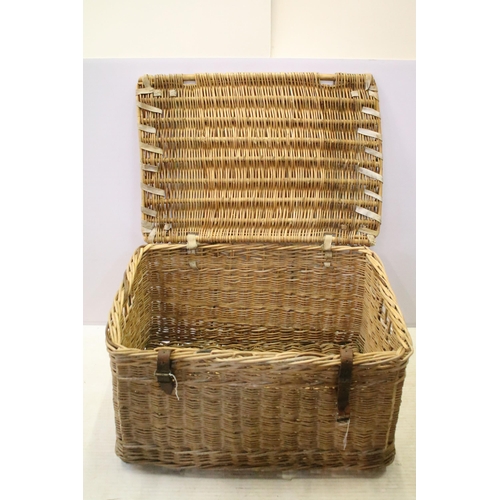 654 - Early 20th century wicker hamper with liftable lid and strap closure, H 48cm W 80cm