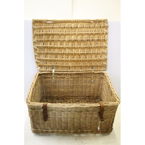 657 - Early 20th century wicker hamper with liftable lid and strap closure, H 46cm, W 82cm