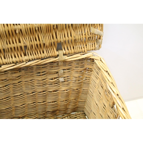 657 - Early 20th century wicker hamper with liftable lid and strap closure, H 46cm, W 82cm