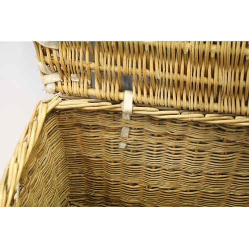 657 - Early 20th century wicker hamper with liftable lid and strap closure, H 46cm, W 82cm