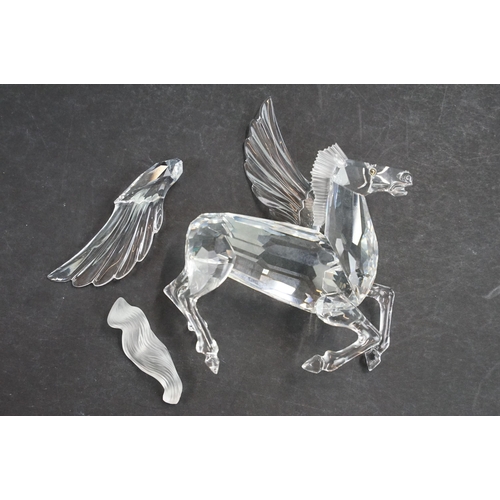 34 - Collection of five Swarovski crystal figurines to include a Pegasus, eagle, horse standing, horse re... 