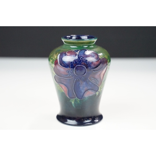 42A - Early to mid 20th century William Moorcroft baluster vase decorated in the anemone pattern on a gree... 