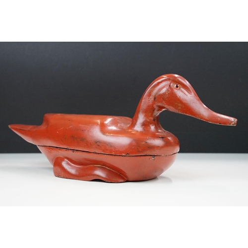 145 - Early 20th century Chinese lacquered lidded box in the form of a duck with glass eyes, 41.5cm long