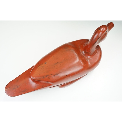 145 - Early 20th century Chinese lacquered lidded box in the form of a duck with glass eyes, 41.5cm long