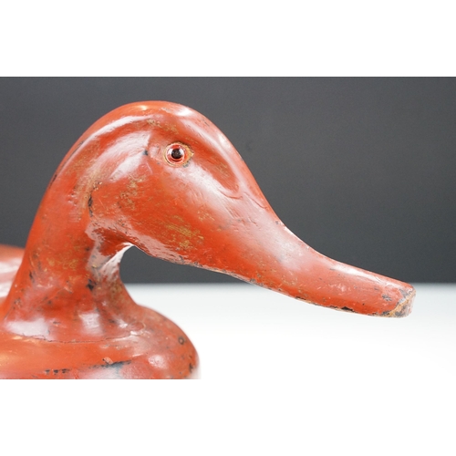 145 - Early 20th century Chinese lacquered lidded box in the form of a duck with glass eyes, 41.5cm long