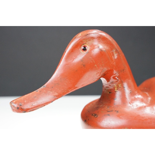 145 - Early 20th century Chinese lacquered lidded box in the form of a duck with glass eyes, 41.5cm long