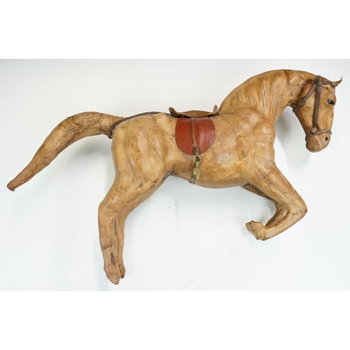 139 - Two 19th century Liberty style leather horse sculptures with saddles