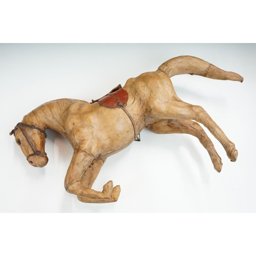 139 - Two 19th century Liberty style leather horse sculptures with saddles