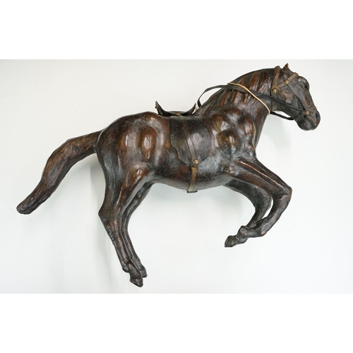 139 - Two 19th century Liberty style leather horse sculptures with saddles