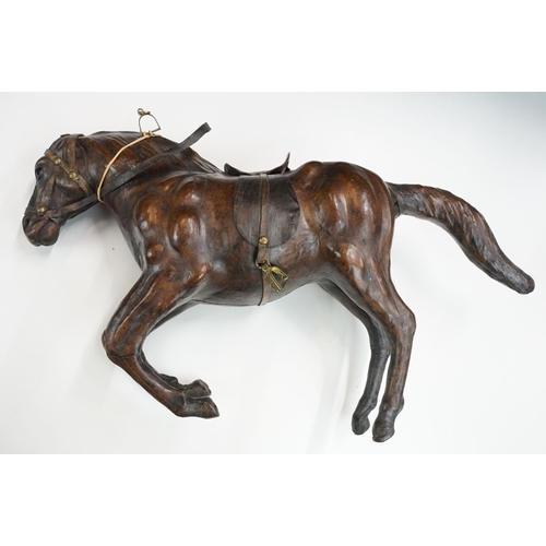 139 - Two 19th century Liberty style leather horse sculptures with saddles