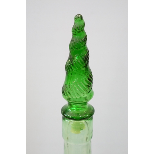 147 - Novelty green glass genie bottle in the form of a woman holding a bottle, 91.5cm high