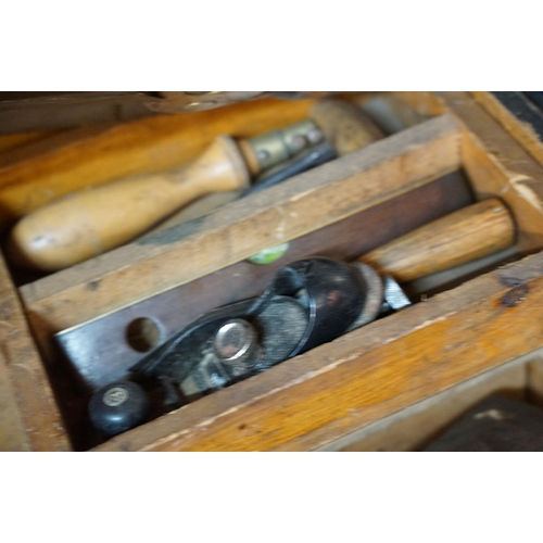 370 - Large wooden tool chest with contents including spirit level, squares, planes, drills saws, etc