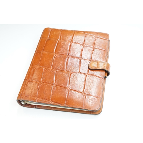 253A - A Mulberry leather planner / filofax together with a a brown leather holdall bag.