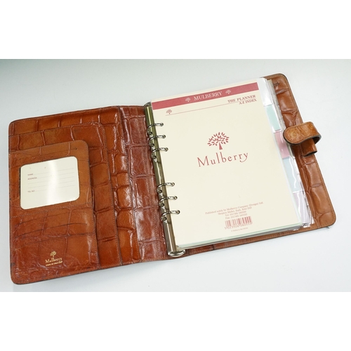 253A - A Mulberry leather planner / filofax together with a a brown leather holdall bag.