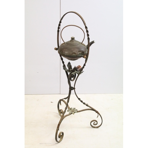 437 - Antique copper kettle on wrought iron base with flower details, H 82cm, together with an antique rus... 