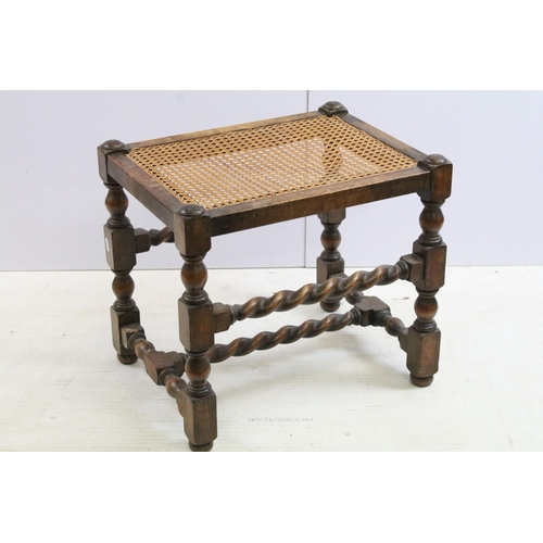 563 - Early 20th century mahogany stool, with turned, twisted stretchered design and canework seat, 45cm h... 