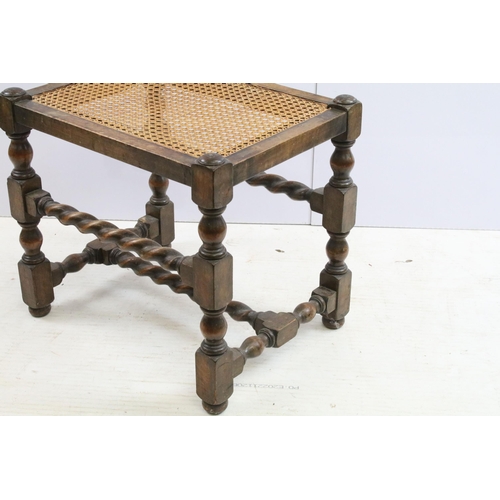 563 - Early 20th century mahogany stool, with turned, twisted stretchered design and canework seat, 45cm h... 