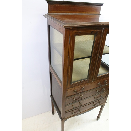 566 - Edwardian mahogany inlaid display cabinet with double glazed doors above an arrangement of four draw... 