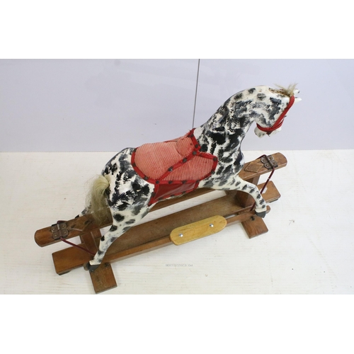 567 - Early / mid 20th century carved wooden dappled painted rocking horse with red saddle and reins, 79cm... 