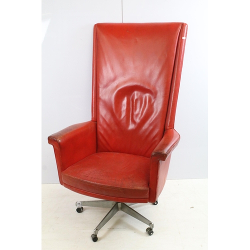 571 - Retro Vintage red leather deep back swivel desk chair with five point caster base, H 122cm