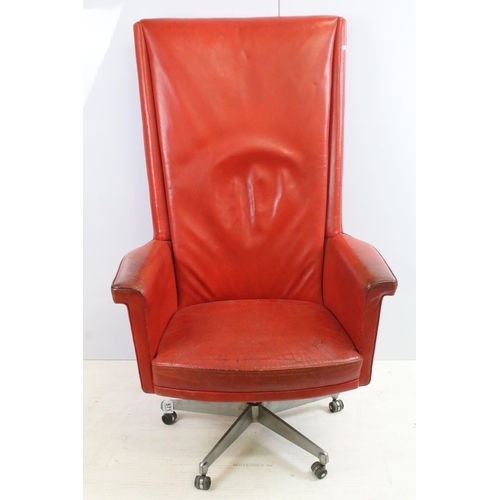 571 - Retro Vintage red leather deep back swivel desk chair with five point caster base, H 122cm