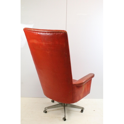 571 - Retro Vintage red leather deep back swivel desk chair with five point caster base, H 122cm