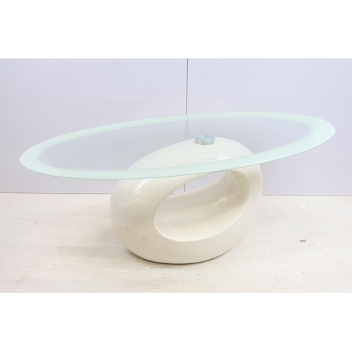 572 - Retro space age style glass oval topped coffee table with white fibre glass base, H 116cm W 60cm