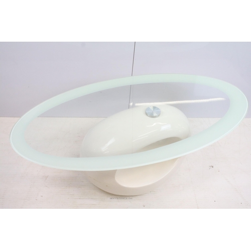 572 - Retro space age style glass oval topped coffee table with white fibre glass base, H 116cm W 60cm