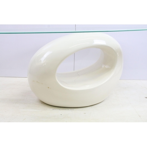 572 - Retro space age style glass oval topped coffee table with white fibre glass base, H 116cm W 60cm