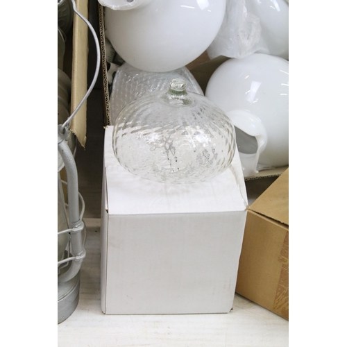 413 - Variety of oil lamp optics and white shades, together with an assortment of storm lanterns