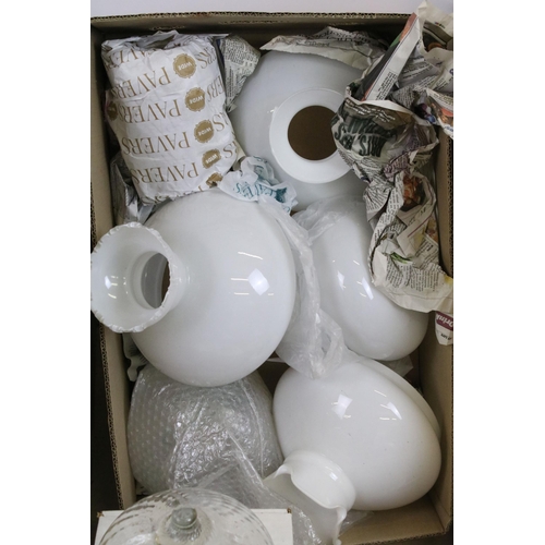 413 - Variety of oil lamp optics and white shades, together with an assortment of storm lanterns