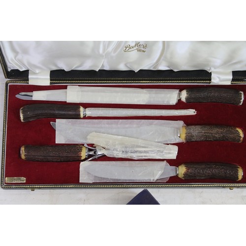 421 - Butler's Sheffield antler handle box of knives and carving items, together with Mother of Pearl hand... 