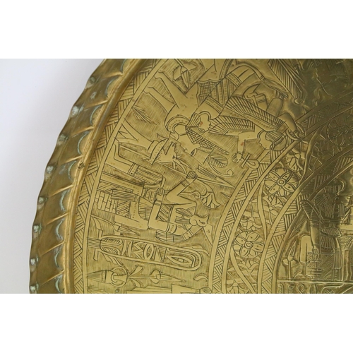 443 - Egyptian brass circular tray with central panel of figures within borders and fluted rim, 69.5cm dia... 