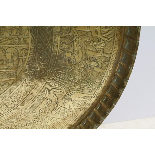 443 - Egyptian brass circular tray with central panel of figures within borders and fluted rim, 69.5cm dia... 