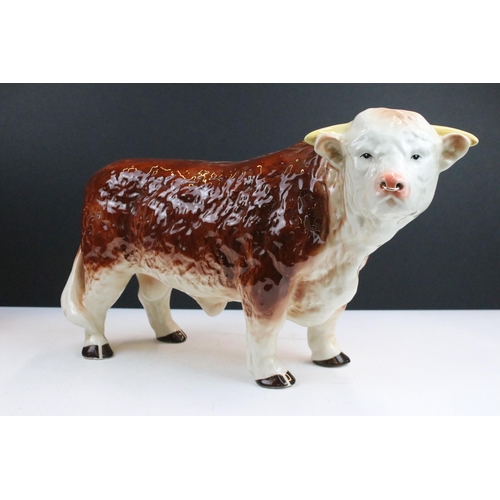 12 - Large Melba ware butcher's Hereford Bull, H 25.5cm together with a smaller Melba ware bull, H 16cm