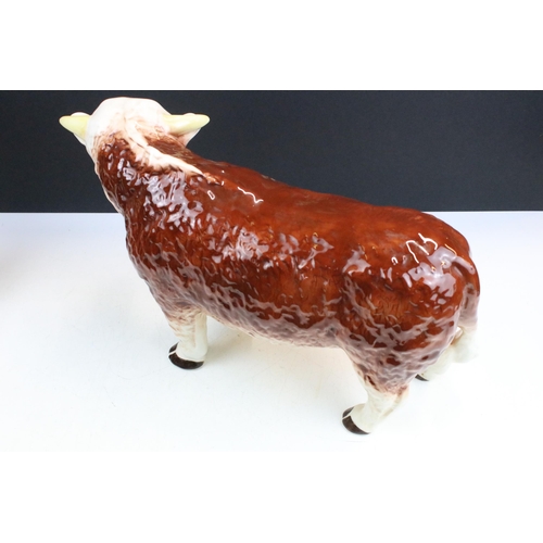 12 - Large Melba ware butcher's Hereford Bull, H 25.5cm together with a smaller Melba ware bull, H 16cm