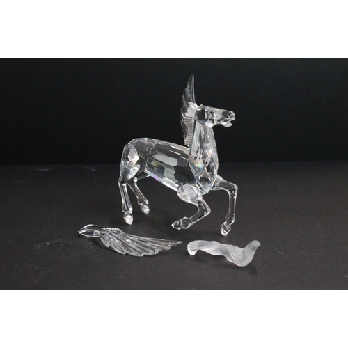 31 - Collection of five Swarovski crystal figurines to include a Pegasus, eagle, horse standing, horse re... 