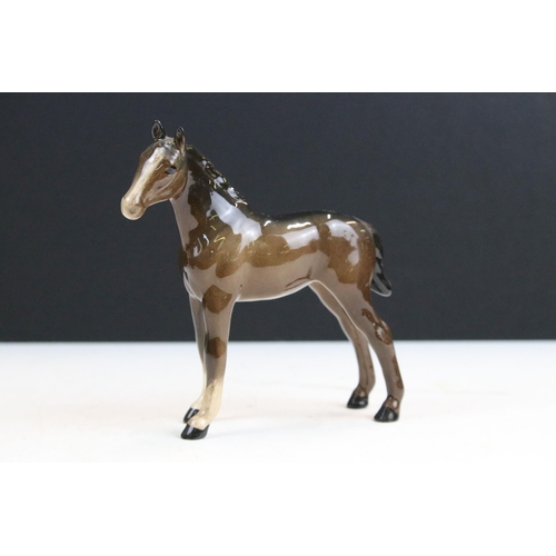 38 - Group of Beswick horses to include three small high gloss brown pony examples together with a Beswic... 