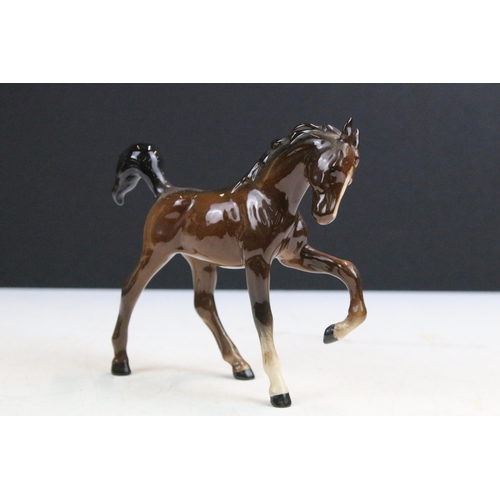 38 - Group of Beswick horses to include three small high gloss brown pony examples together with a Beswic... 