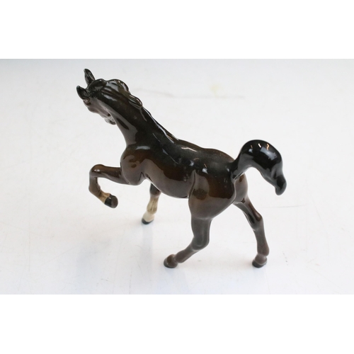 38 - Group of Beswick horses to include three small high gloss brown pony examples together with a Beswic... 